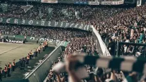 Esports betting fans packed into a stadium at night watching a tournament