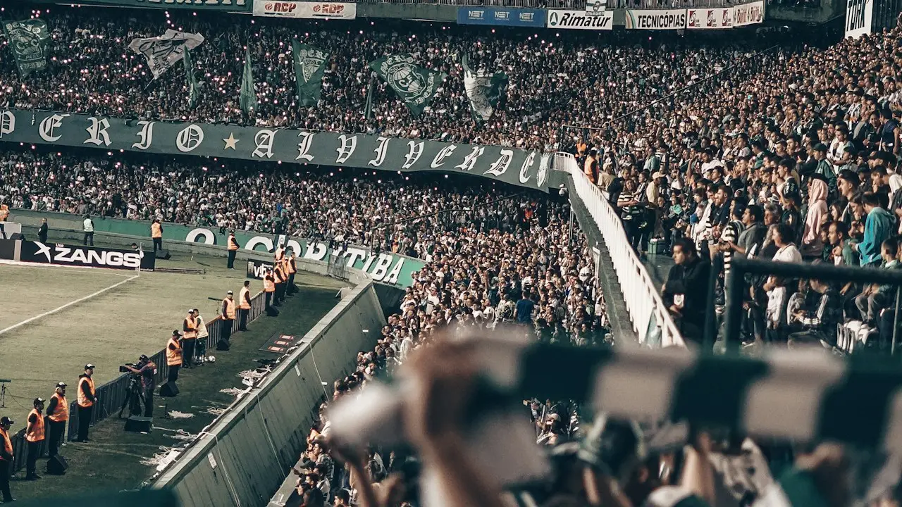 Esports betting fans packed into a stadium at night watching a tournament