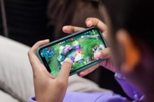 games that pay real money person playing mobile game app on smartphone