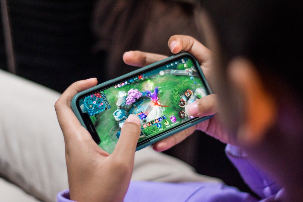 games that pay real money person playing mobile game app on smartphone