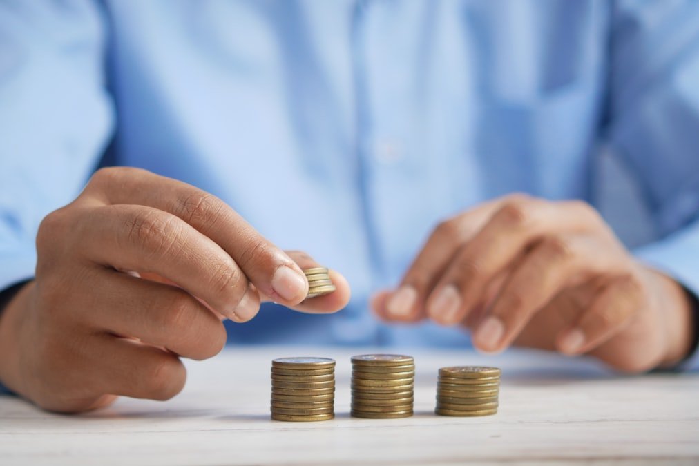 passive income ideas person stacking coins to build long-term wealth