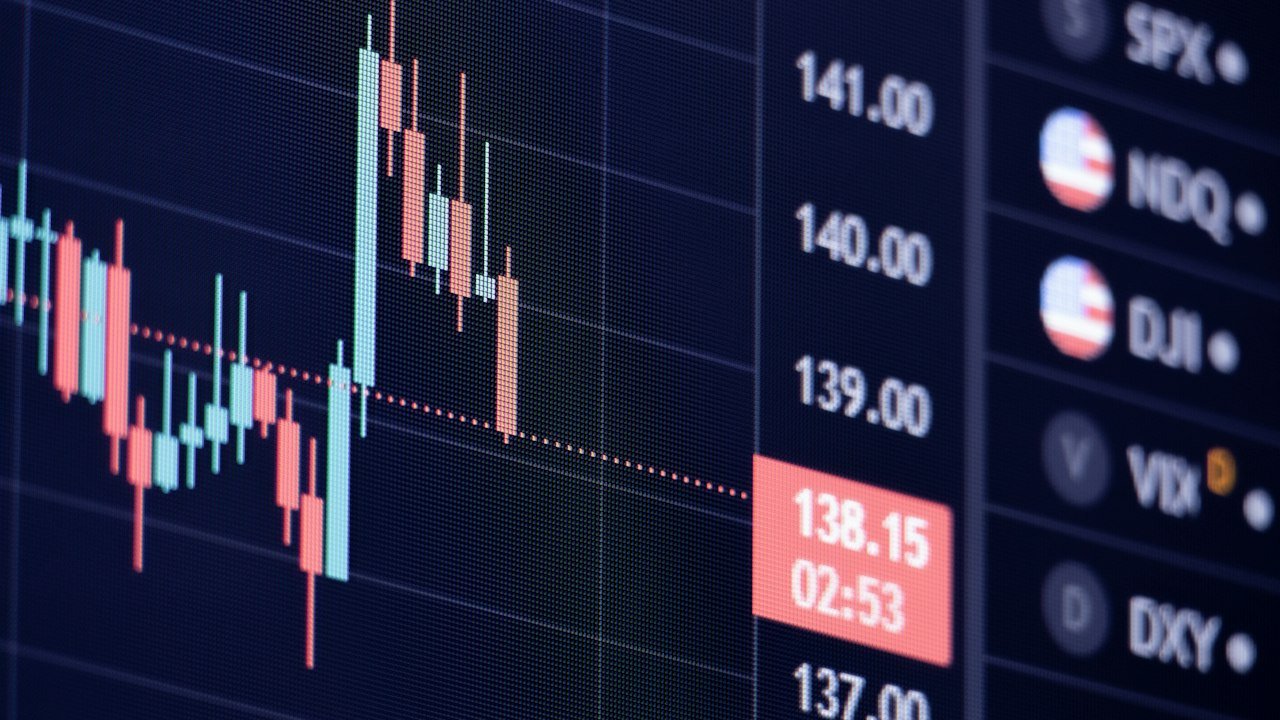 Candlestick chart on a dark screen used to compare ether ETF staking fund performance