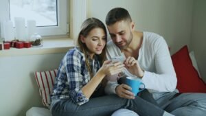Couple looking at a smartphone together while comparing a Roth IRA vs traditional IRA