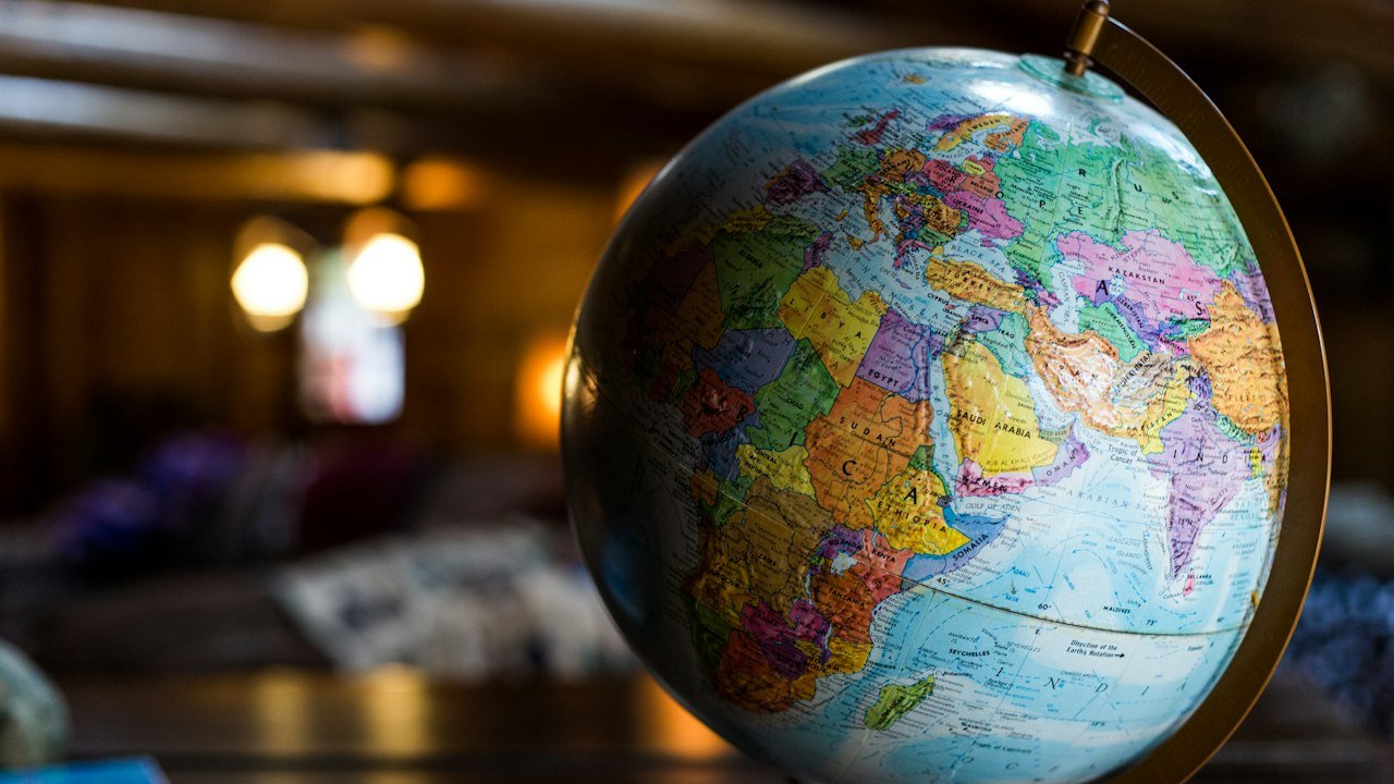 Desk globe on a table, a picture for the Upstox NRI account question for investors abroad