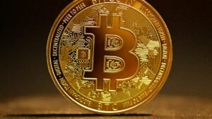 Golden bitcoin coin on a table representing bitcoin ETF inflows
