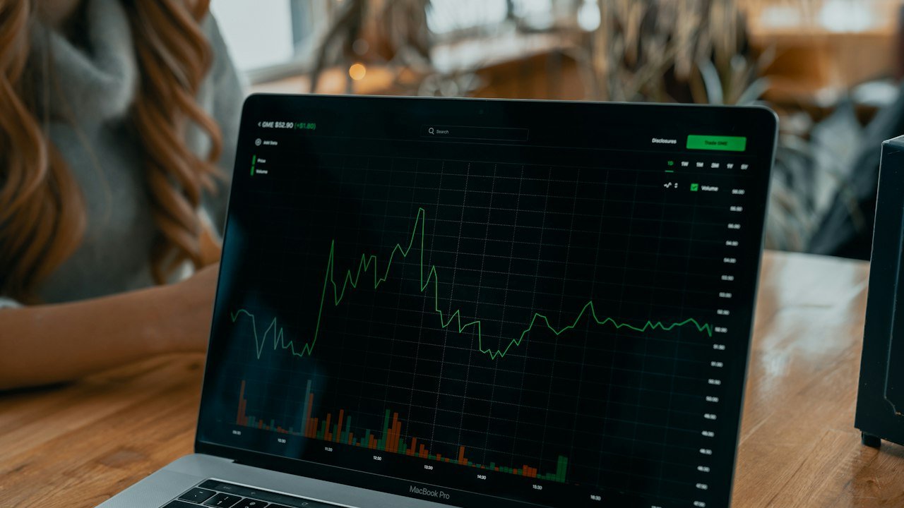 Laptop showing a stock chart for a beginner learning how to start investing in stocks