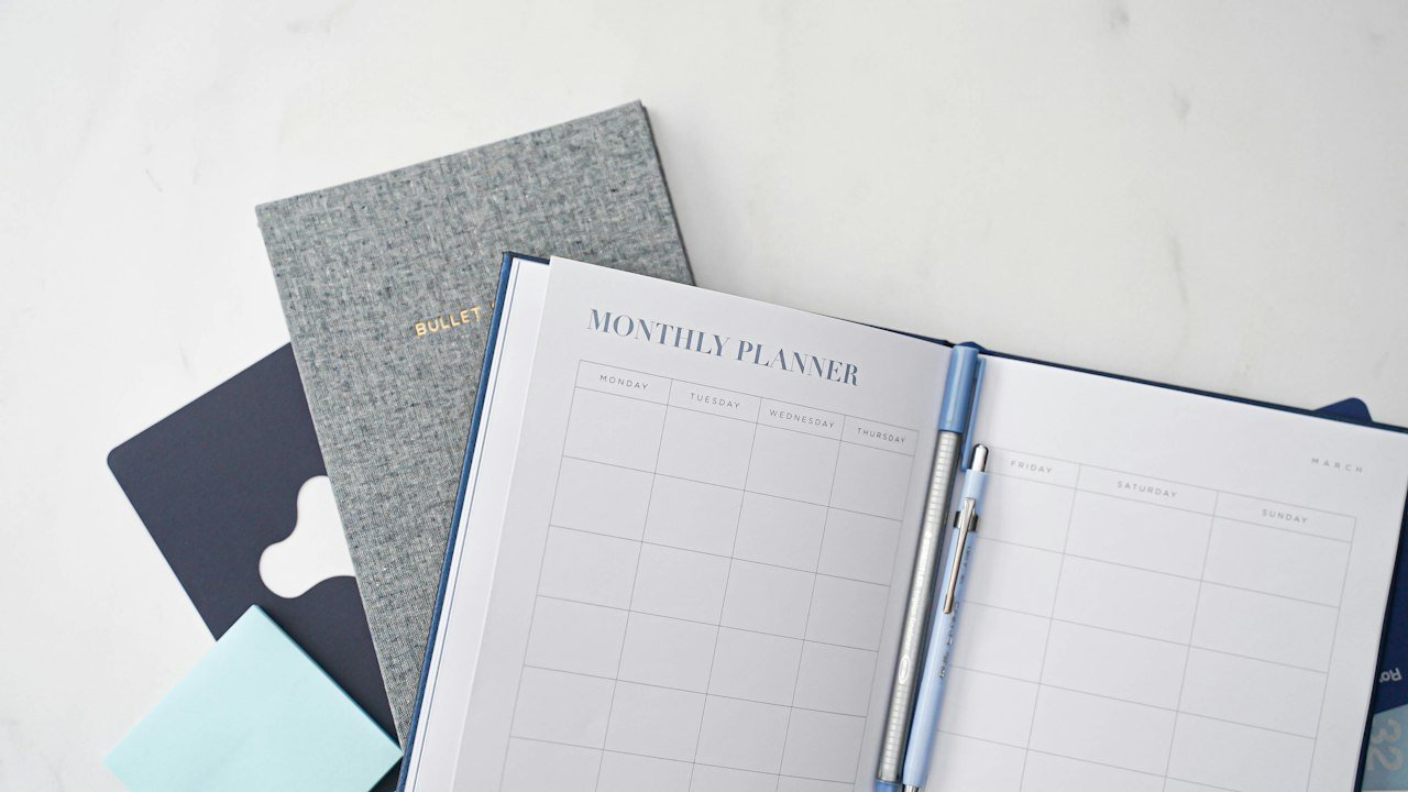 Pen and notebook used to plan savings under the 2027 retirement contribution limits