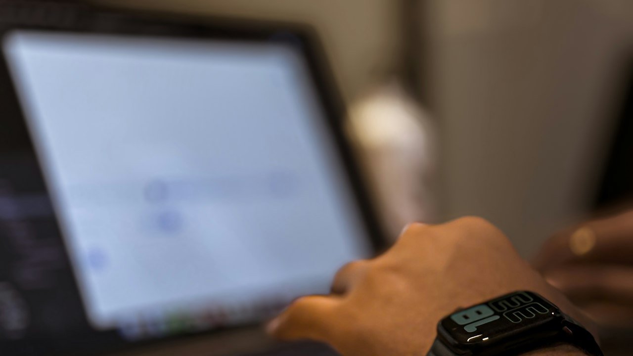 Person using a laptop on a desk to learn how to use ChatGPT