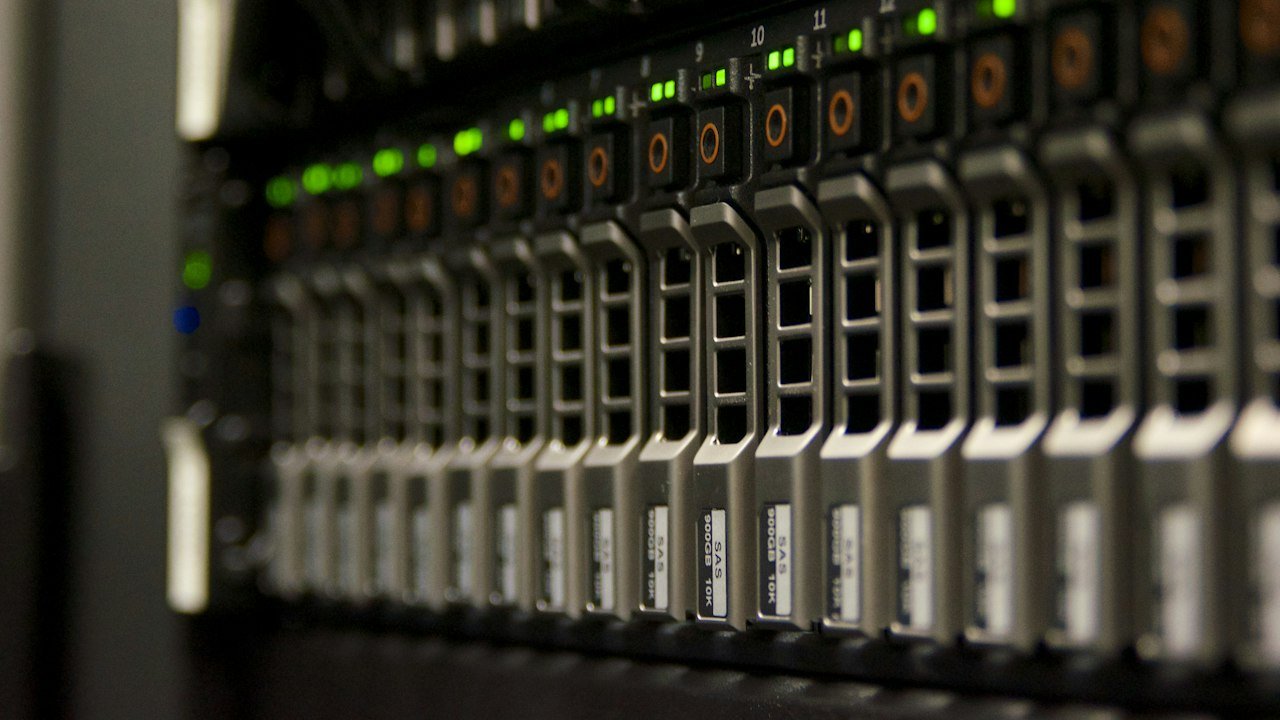 Server rack with green lights representing AWS cloud capacity in the Amazon stock forecast