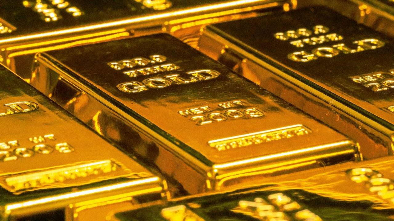 Stacked gold bullion bars showing how to invest in gold