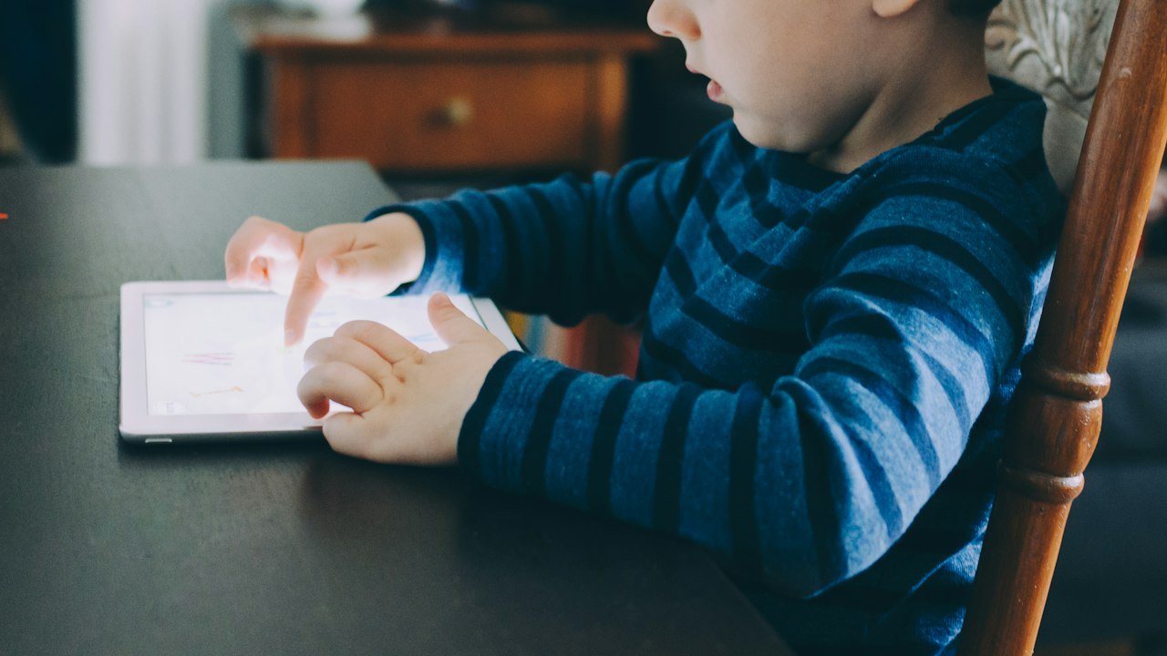 Young player on a tablet after learning how to download Roblox safely